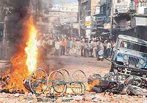 Vehicles go up in flames as the police tries to check riotous mobs in Lucknow on Friday.