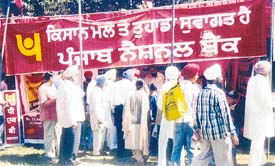 Farmers visit a stall put up by Punjab National Bank at the PAU kisan mela
