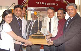 Students of the Institute of Law, Kurukshetra University, receive the trophy of the first Payare Lal Rukmani Devi consumer moot court competition from Justice S.K. Jain at the Rayat College of Law at Ropar on Sunday.