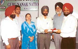 Dr Narinder Singh, Principal, and Mr Jaswant Singh Gill, director, of Guru Nanak National College honour the resource person during a seminar at Doraha, on Monday
