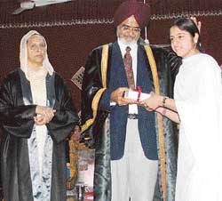 Dr Kanwaljit Singh, DPI, awards a meritorious student of the Government College for Women, Ludhiana, on Tuesday