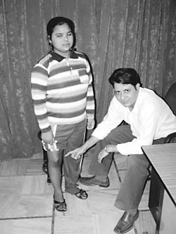 Pawan Kumari shows the custom-made imported titanium knee which has replaced her cancer-afflicted joint