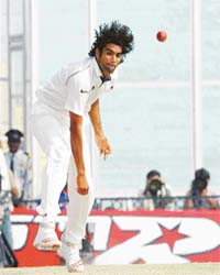 Test debutant medium-pacer Munaf Patel sends down a scorching delivery on the last day of the second Test match in Mohali