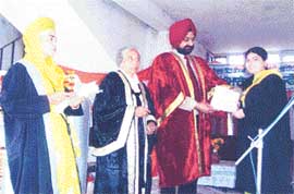 Dr Harbans Singh Sidhu, Chairman, Punjab School Education Board, presents a degree to a student of Government Girls College, Tooran, near Mandi Gobindgarh, on Tuesday.