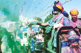 Nihang Singhs throw dry colours on devotees during Hola Mohalla in Anandpur Sahib
