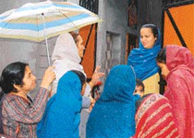 The rain is no deterrent for these volunteers of Upkaar on a house visit to inquire about the welfare of a mother-to-be in Khothran village of Nawanshar district in Punjab