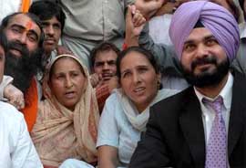 Mr Navjot Singh Sidhu along with Ms Dalbir Kaur during a protest in Amritsar on Thursday.