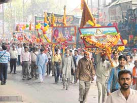 Devotees take part in Baba Balak Nath Paidal Yatra near Railway Station in Ludhiana on Monday.