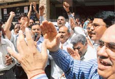 Employees of the State Bank of India demonstrate outside the main branch of the bank in Parliament Street in New Delhi on Monday during a nationwide indefinite strike