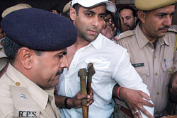 Bollywood star Salman Khan is escorted by policemen outside a court in Jodhpur on Monday, after he was sentenced to five years in prison.