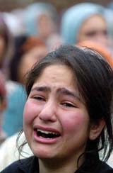A girl grieves for her relative Javed Ahmed Bhat who was among five civilians killed in a series of grenade blasts in Srinagar on Friday