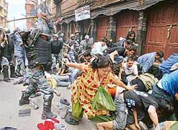 Injured protesters lie as police baton charge pro-democracy protesters, within a mile from the royal Narayanhiti Palace in Kathmandu on Saturday.