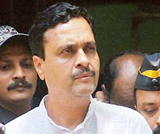Policemen escort Pravin Mahajan, the brother of Pramod Mahajan, out of a court in Mumbai on Sunday. 