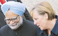 German Chancellor Angela Merkel talks to Prime Minister Manmohan Singh after they reviewed a German Bundeswehr army guard of honour upon his arrival in Hannover on Sunday.