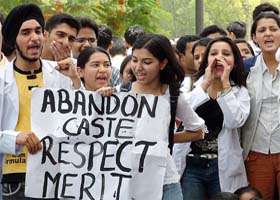 Agitating students of Delhi shout slogans during a protest against reservation in Delhi