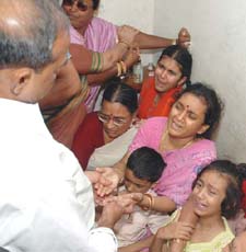 Manjula Narayan is consoled by Chief Minister of Andhra Pradesh Y.S. Rajashekar Reddy as she grieves with family members at her home in Hyderabad on Sunday after hearing the news that the body of her husband Suryanarayan has been found in Afghanistan.