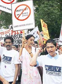 HIV/AIDS patients and members under the banner of the Indian Network for People Living with HIV/AIDS shout slogans during a march in New Delhi on Wednesday.