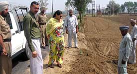 Dr Indu, SDM, Malerkotla, supervises the filling work on a land surrendered by a farmer along a link road connecting Mandi Ahmedgarh with Baurhai Kalan village