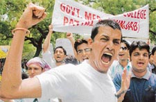 A medical student from Punjab shouts anti-reservation slogan during a huge anti-quota rally called by junior doctors and medical students to protest the reservation policy, in New Delhi on Saturday