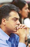 Stock dealers watch share prices plunge on their monitors in Mumbai