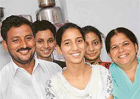 Monica Sharma surrounded by her elated family members