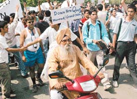 This elderly couple on a scooter with the lady holding a banner, saying "Down with quota", join the medical students in their rally in Chandigarh on Saturday.