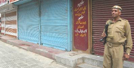 A securityman stands guard in Srinagar during a bandh on Thursday.