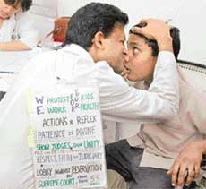 Dr Bhanu Prakash of the Department of Neurosurgery, PGI, who is still on the warpath against the reservation policy of the government. He examines patients with a protest placard still hanging on his back.