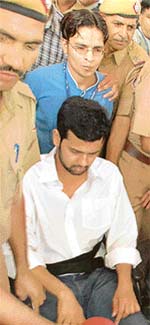 Rahul Mahajan being taken by the police after his discharge from Apollo Hospital in New Delhi