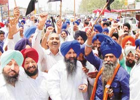 Workers of the SAD (B) block the Patiala-Rajpura road to protest against petrol price hike