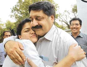 The late BJP leader Pramod Mahajan’s secretary, Harish Sharma, hugs Mahajan’s daughter Poonam after the hearing of Rahul Mahajan’s release on bail in New Delhi