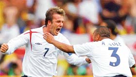England’s David Beckham celebrates his goal against Ecuador with team-mate Ashley Cole during their second round World Cup match in Stuttgart