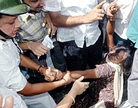 The police carries an unconscious woman activist of the Chhatra Parishad, students wing of the Congress, during a demonstration against the increase in capitation fees and prices of essential commodities in Kolkata on Thursday.
