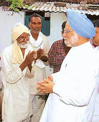 Prime Minister Manmohan Singh meets residents of Dhamanga village in Wardha district on Saturday.