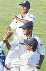 Indian cricket captain Rahul Dravid is carried off the field by teammates S. Sreesanth and Mohammad Kaif after the fourth and final Test match at the Sabina Park Stadium in Kingston, Jamaica, on Monday