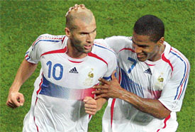 French midfielder Florent Malouda congratulates Zinedine Zidane