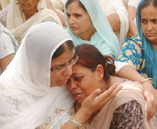 Wailing relatives of IAS officer, Dr Aman Singh, whose parents were killed in a gruesome manner in Bhikhiwind town on Wednesday