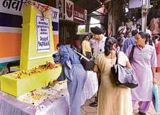 Commuters pay tribute to train blast victims at a memorial site at the Andheri railway station in Mumbai on Thursday