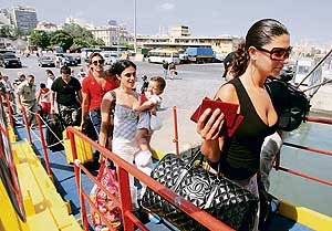 Lebanese-born Swedish nationals and tourists board a ship in Beirut to be evacuated due to the Israeli military offensive on Lebanon on Wednesday.