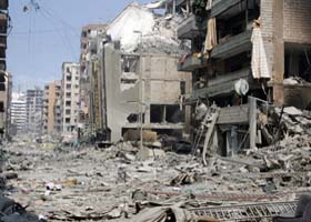 Buildings destroyed by Israeli air strikes stand among the debris in southern Beirut