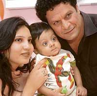 One-year-old Sheryar from Karachi, Pakistan, the youngest recipient of a successful liver transplant in India, plays in the arms of his parents at Sir Ganga Ram Hospital in New Delhi on Wednesday. 