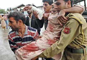 An injured person being taken to hospital after militants attacked a police patrol party at the main chowk, Sopore, in Baramulla district of north Kashmir