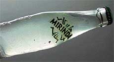 Foreign matter floats in a soft drink bottle.