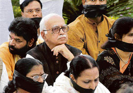 MPs of the NDA sit at a dharna in front of the Gandhi statue at the Parliament House in New Delhi on Tuesday to protest against the Lok Sabha Speaker, Mr Somnath Chatterjee. Also seen in the picture is the Leader of Opposition in the Lok Sabha and senior BJP leader, Mr L.K. Advani.