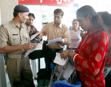 Airline passengers undergo security checks at the domestic airport in New Delhi on Friday