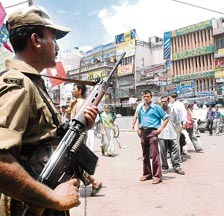 A securityman keeps a vigil in the walled city area near the Red Fort in Delhi on Saturday