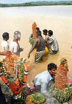 Devotees offer prayers on the conclusion of the Sheetla Mata festival at the Sukhna Lake