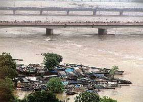 A slum cluster on the banks of the river Sabarmati in Ahmedabad is completely submerged in the overflowing waters