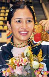 Indias Jawala Gutta shows the two gold medals won by her in badminton at the South Asian Games in Colombo on Friday