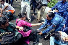 RAF personnel drag agitating medicos during the anti-reservation demonstration outside the Supreme Court in New Delhi on Thursday